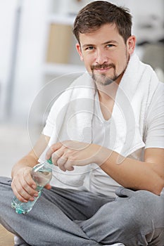 young sporty man holding bottle water