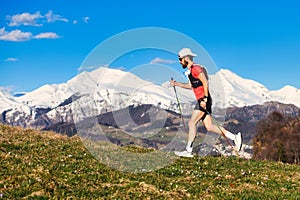 Young sporty man practices nordic walking