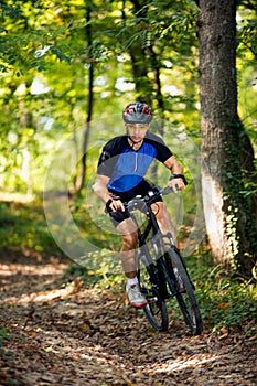 Young sporty man practicing mountain biking