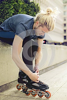 Young sporty man with skaters