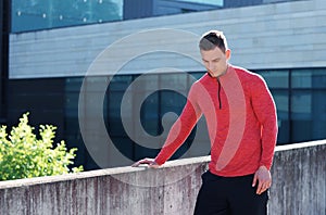 Young and sporty man training outdoor in sportswear. Sport, health, athletics.