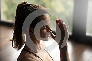 Young sporty woman in Alternate Nostril Breathing photo