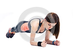 Young sporty woman doing exercises on the floor