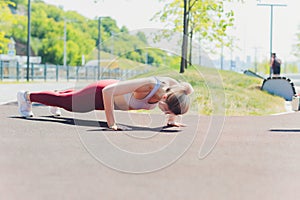 Young Sporty woman doing stretching exercise promenade.