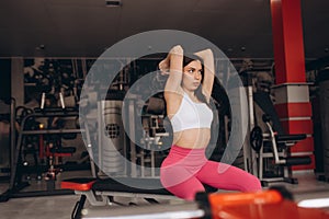 Young sporty woman doing triceps extension with dumbbell in gym. Diet lifestyle, weight loss, gain muscle, healthy and