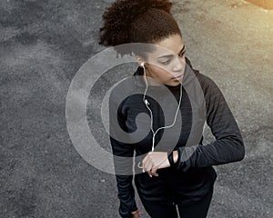 Young sporty woman with fitness tracker