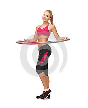 Young sporty woman with hula hoop