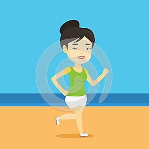 Young sporty woman jogging on the beach.