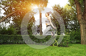 Young sporty woman with jumping rope