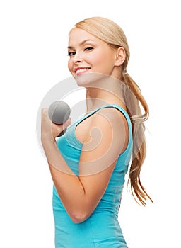 Young sporty woman with light dumbbells