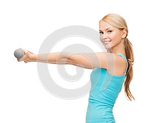 Young sporty woman with light dumbbells