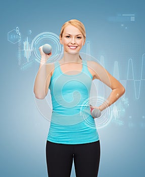 Young sporty woman with light dumbbells