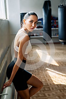 Young sporty woman posing in fitness gym