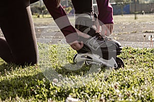 young sporty woman practicing inline skating in an urban setting. Preparing herself to skate.