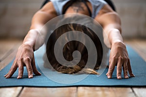 Young sporty woman practicing yoga, doing Balasana exercise, clo