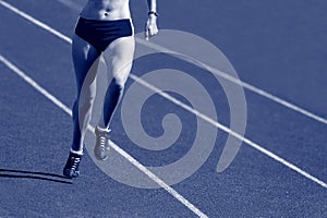 Young sporty woman running on sunny day