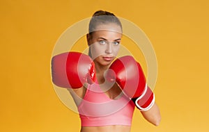 Young Sporty Woman Wearing Red Boxing Gloves, Ready To Attack