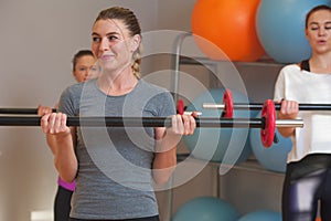 Young sporty women exercising in fitness class.