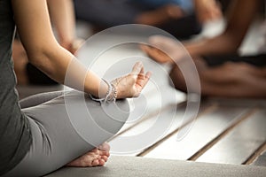 Young sporty woman in Sukhasana exercise, close up