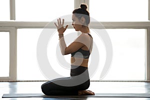 Young sporty yogi woman practicing yoga, doing seiza exercise