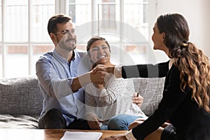 Young spouse shaking hands with professional financial consultant.