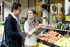 Young spouses choosing sweet fruits