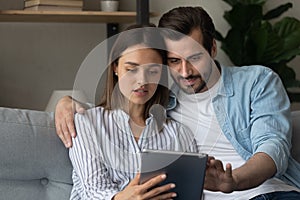 Young spouses hold digital pad buy goods order service online photo
