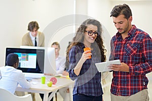 Young startup business people, couple working on tablet computer