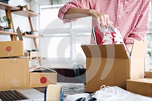 Young startup entrepreneur small business owner working at home, packaging and delivery situation.