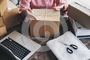 Young startup entrepreneur small business owner working at home, packaging and delivery situation. photo