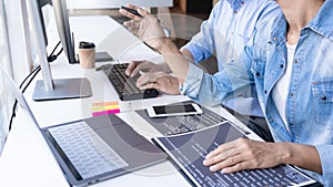 Young startup Programmers Sitting At Desks Working On Computers screen for Developing programming and coding to find solution to