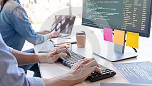 Young startup Programmers Sitting At Desks Working On Computers screen for Developing programming and coding to find solution to