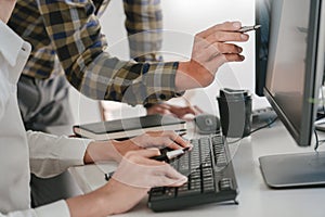 Young startup Programmers Sitting At Desks Working On Computers screen for Developing programming and coding to find solution to