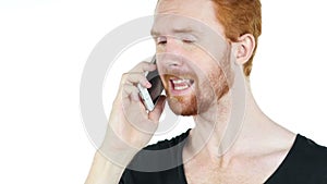 A young stressed angry depressed man aggressively talking on the phone