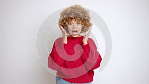 Young stressed curly haired woman, shouting, isolated over white background