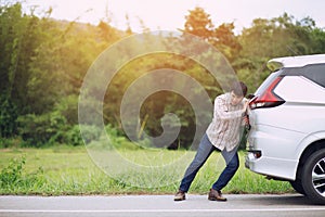 Young stressed man having trouble with his Stress broken car