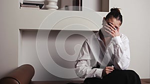 Young stressed woman crying and taking napkin to wipe tears during therapy session, psychologist comforting her