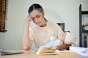 Young stressful mother working from home and raising baby at the same time