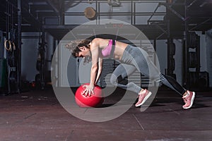 Young strong fit sweaty muscular girl with big muscles doing push ups and running for hard core cross strength workout training