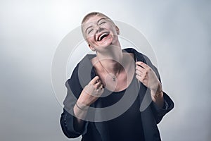 Young, strong, laughing woman with very short blond hair