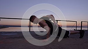 Young Strong Man Doing Push-ups On One Hand While Training