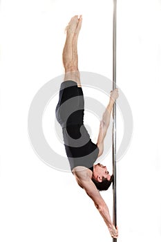 Young strong pole dancer smiling man in black clothes on pylon. White background