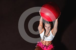 Young strong serious sweaty focused athlete fit muscular woman with big muscles holding heavy kettlebell weight barbell dumbbell