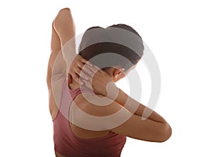 Young strong sporty woman suffering from chronic neck pain. Touching and massaging the hands. Closeup portrait isolated on white