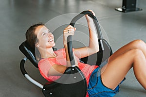 Young strong woman working out in gym