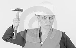 Young strong woman works as builder. Feminism concept.