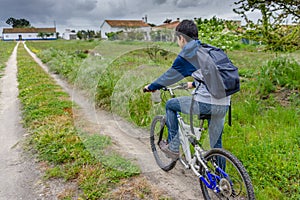 Young student with backpack and bicycle. Go to school. Copy spac