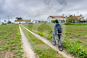 Young student with backpack and bicycle. Go to school. Copy spac