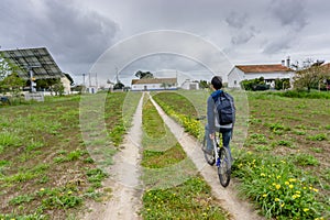 Young student with backpack and bicycle. Go to school. Copy spac