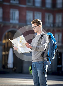 Young student backpacker tourist looking city map in holidays travel